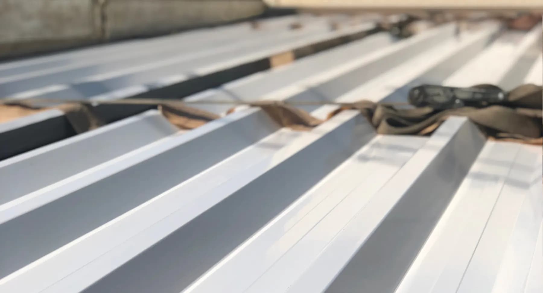 Stack of white trapezoidal profiled sheets, close-up